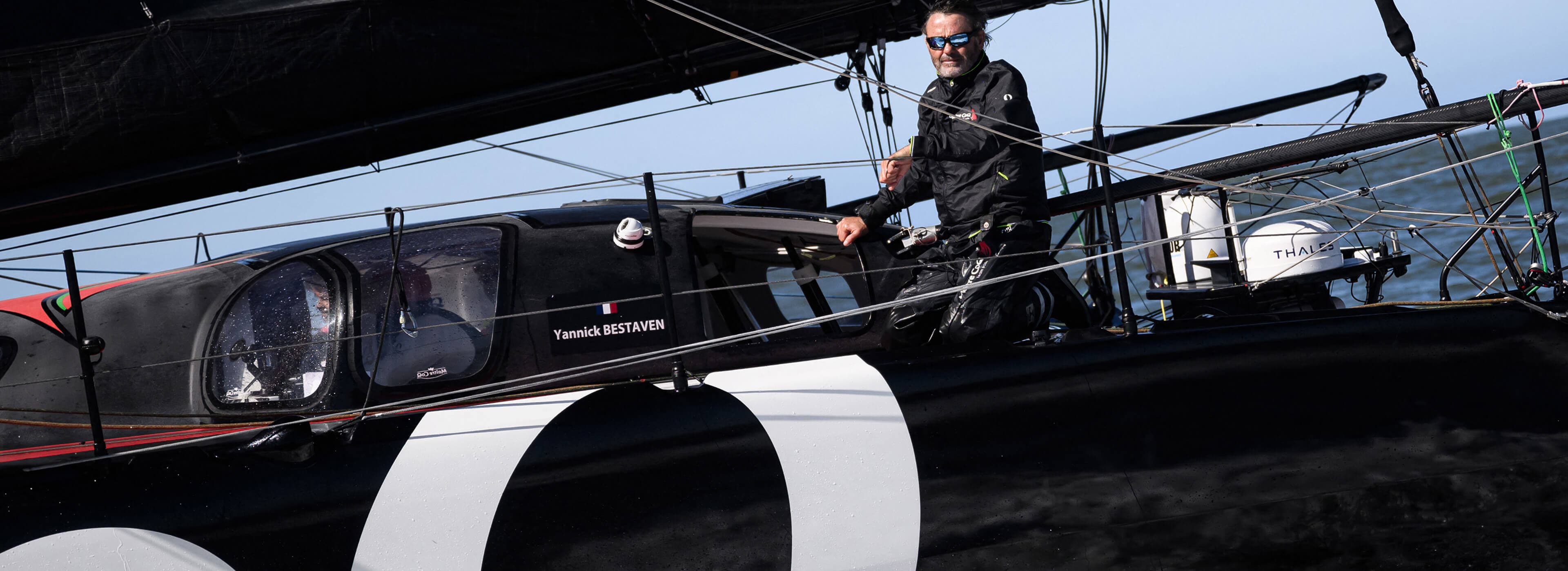 Crew sailing on racing yacht