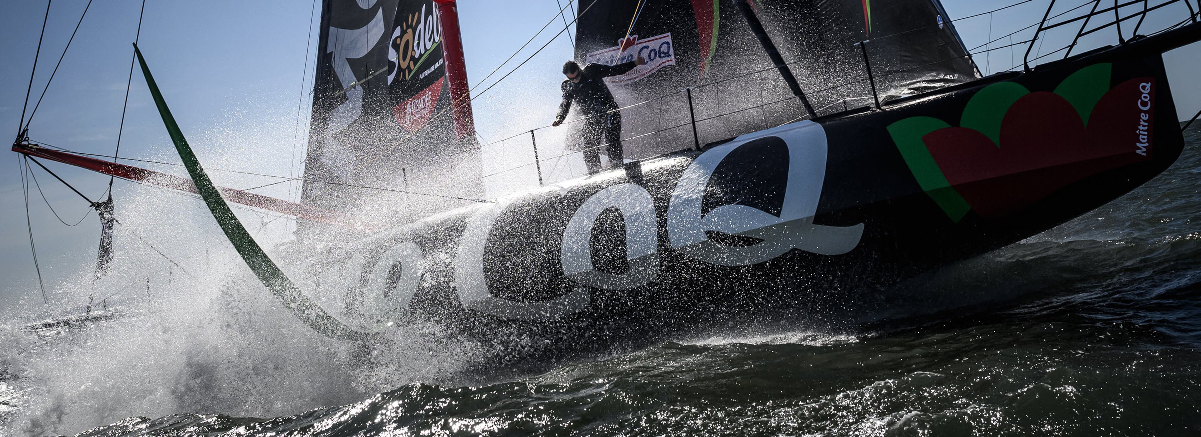 Crew sailing on racing yacht