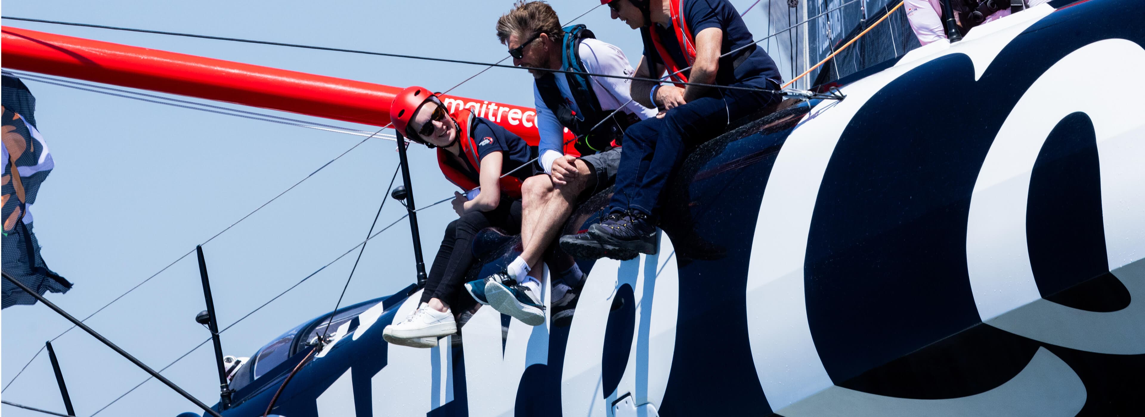 Crew sailing on racing yacht